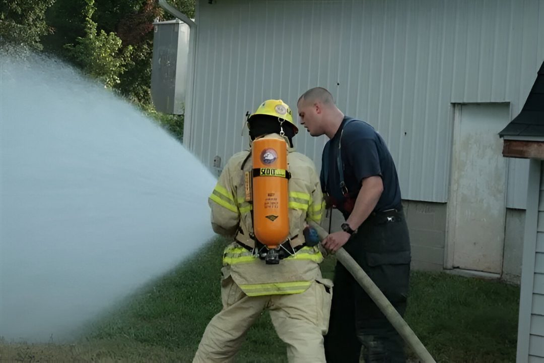 Training drill with firefighters and hose